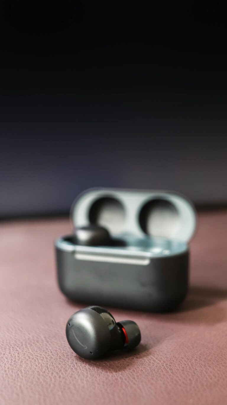 High-quality wireless earbuds with charging case on a stylish backdrop, highlighting their modern design.