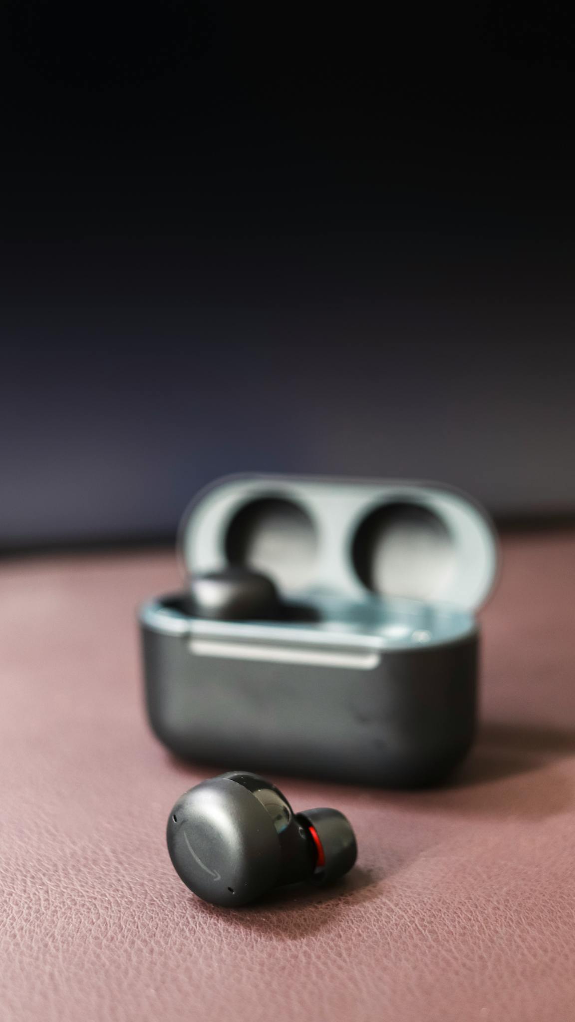 High-quality wireless earbuds with charging case on a stylish backdrop, highlighting their modern design.